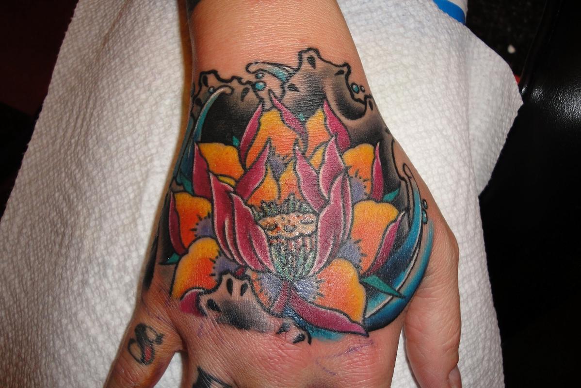 Lotus Flower Hand Tattoo by KR Rossi TattooNOW